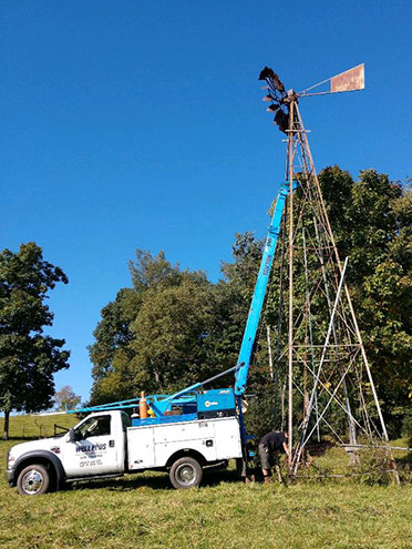 Well Pros truck near windmill tower